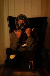 a man sitting in a chair with a mask on his face